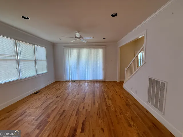 wooden floor in an empty room with a window