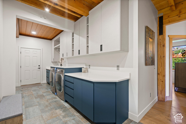5878 Snowbasin Road Huntsville, UT 84317 - Photo 25 of 90 Exposed wood beam ceiling, white upper cabinetry, blue lower cabinetry, white countertops, and tile flooring