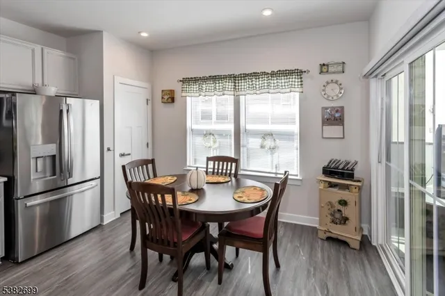a view of a dining room with furniture large window and wooden floor