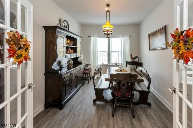 a view of a dining room with furniture and a window