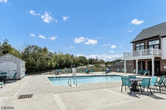 a view of a swimming pool and lounge chairs