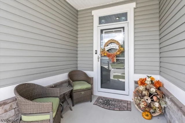 a front view of a house with outdoor seating