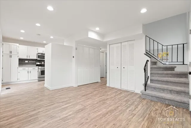 a view of a kitchen with wooden floor and electronic appliances