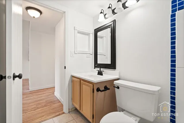 a bathroom with a toilet a sink and mirror