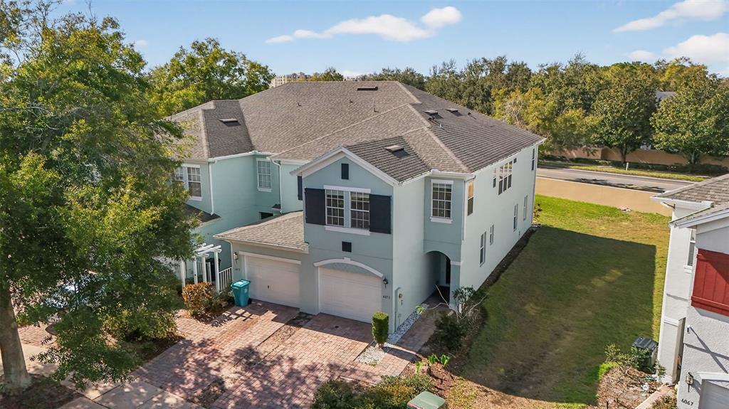 an aerial view of a house with a yard