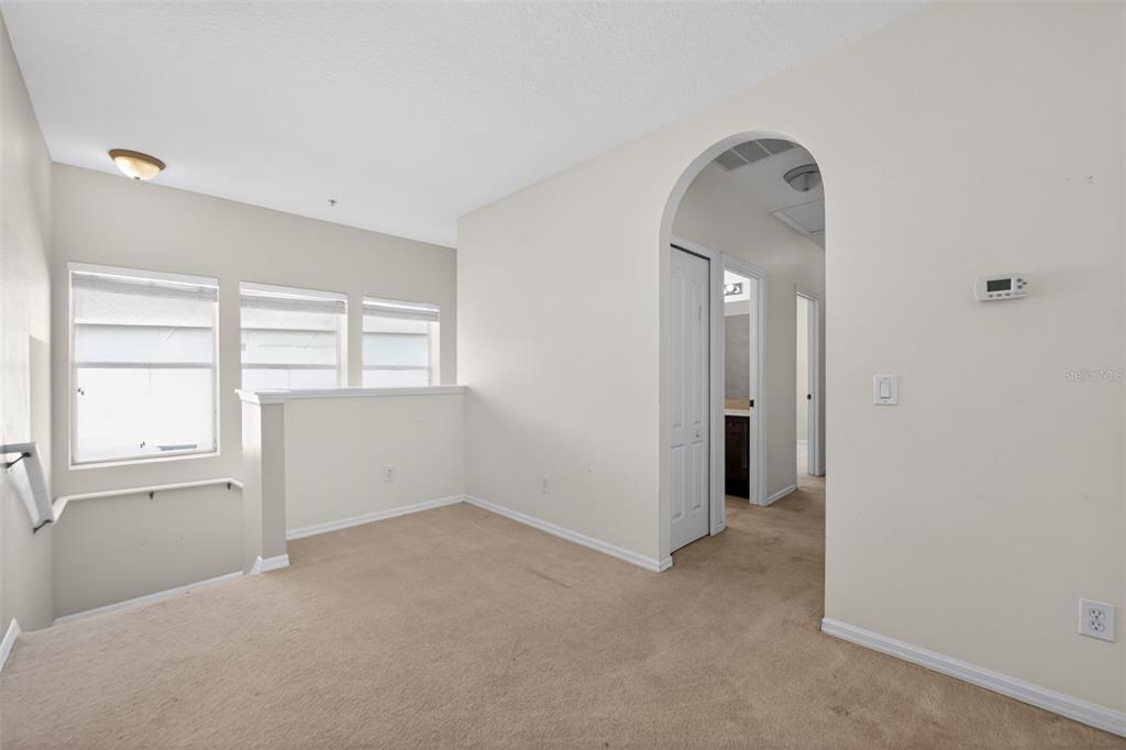 6071 Strada Isle Way Orlando, FL 32835 - Photo 16 of 29 an empty room with windows and closet