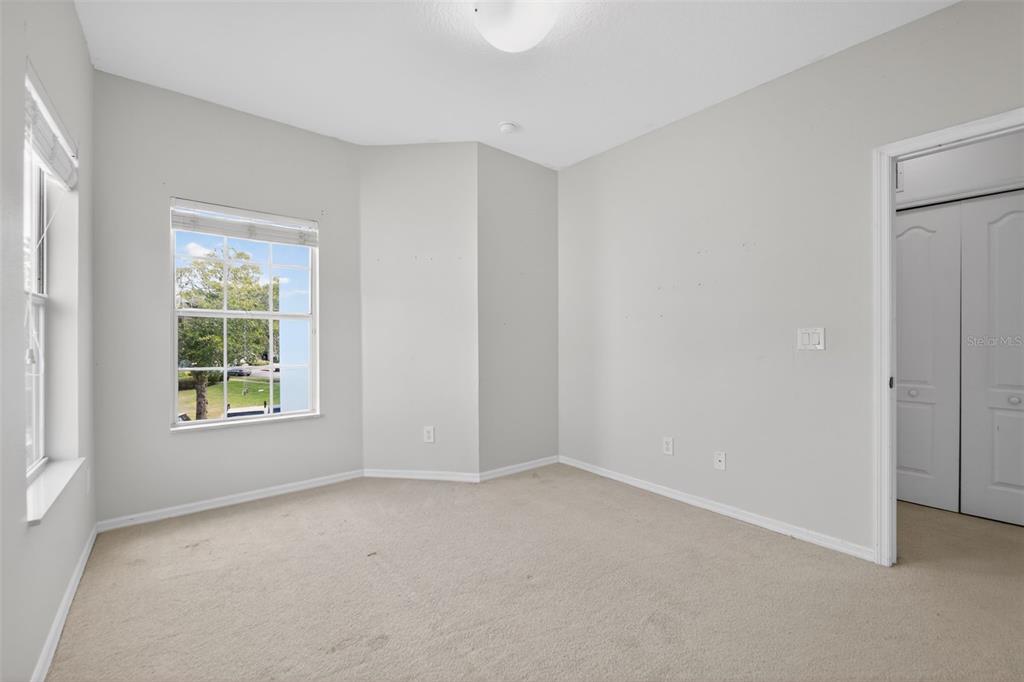 6071 Strada Isle Way Orlando, FL 32835 - Photo 17 of 29 an empty room with windows