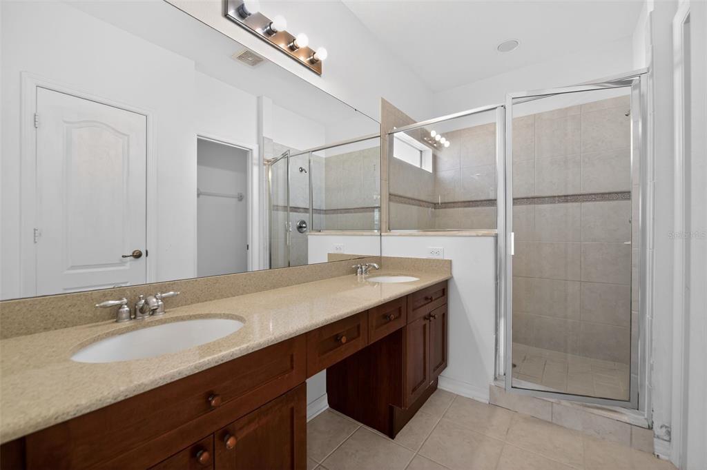 6071 Strada Isle Way Orlando, FL 32835 - Photo 24 of 29 a bathroom with a granite countertop sink mirror and double