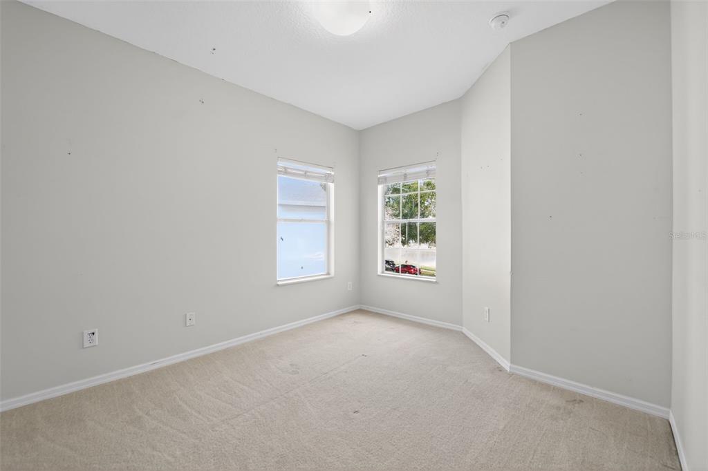 6071 Strada Isle Way Orlando, FL 32835 - Photo 8 of 29 an empty room with windows