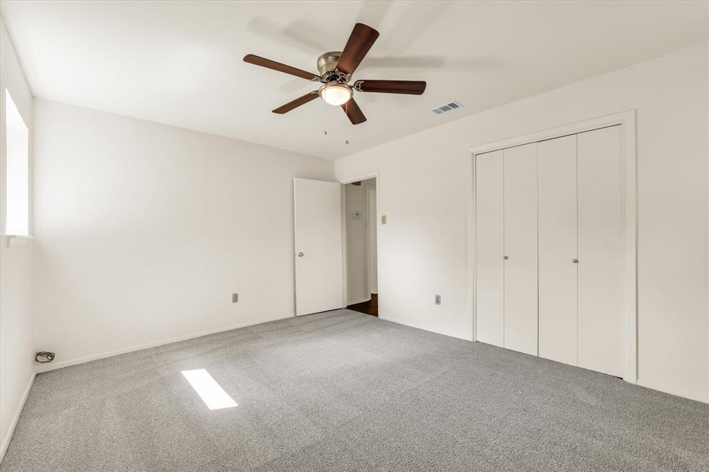 141 Travis Lane Hewitt, TX 76643 - Photo 18 of 31 Room featuring light gray carpeting, neutral wall paint, and a ceiling fan with integrated lighting