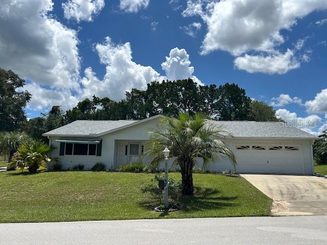 8602 Southwest 116th Place Road Ocala, FL 34481 - Photo 46 of 46 a front view of a house with garden