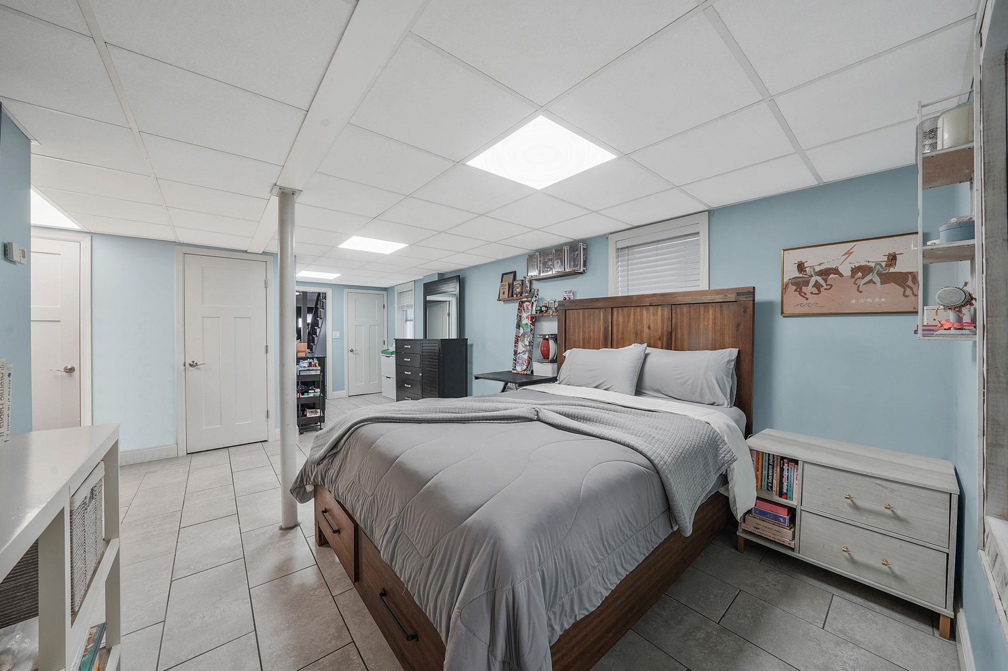 28 West 13th Road Queens, NY 11693 - Photo 11 of 37 a bed room with a bed and a night stand