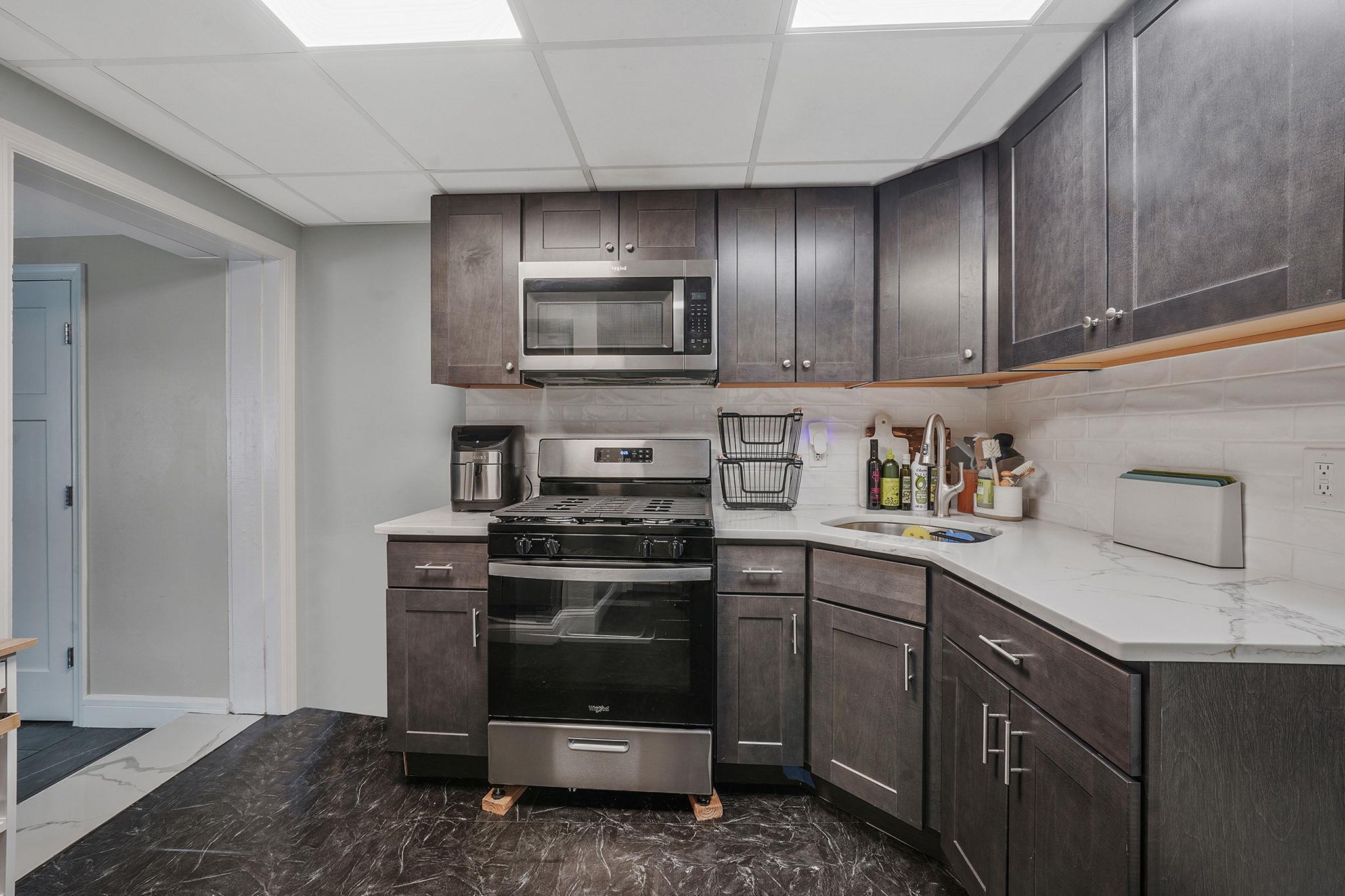 28 West 13th Road Queens, NY 11693 - Photo 14 of 37 a kitchen with cabinets stainless steel appliances and sink