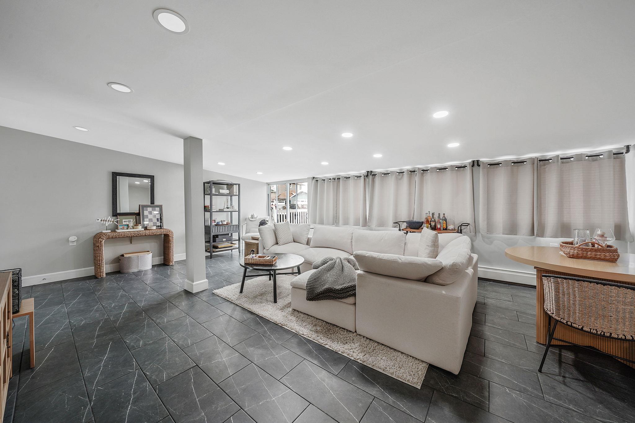 28 West 13th Road Queens, NY 11693 - Photo 17 of 37 a living room with furniture and a table