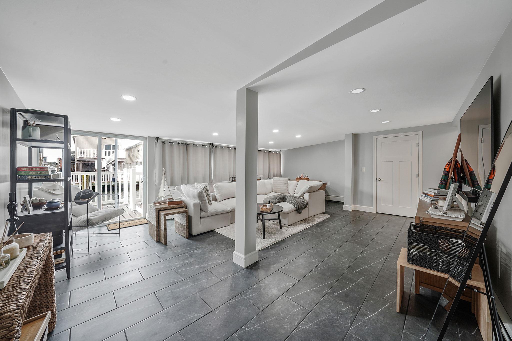 28 West 13th Road Queens, NY 11693 - Photo 19 of 37 a living room with furniture and a flat screen tv