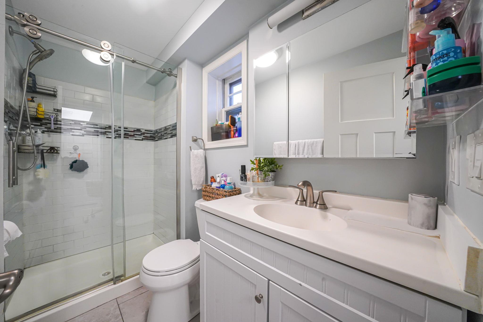 28 West 13th Road Queens, NY 11693 - Photo 21 of 37 a bathroom with a sink toilet and shower
