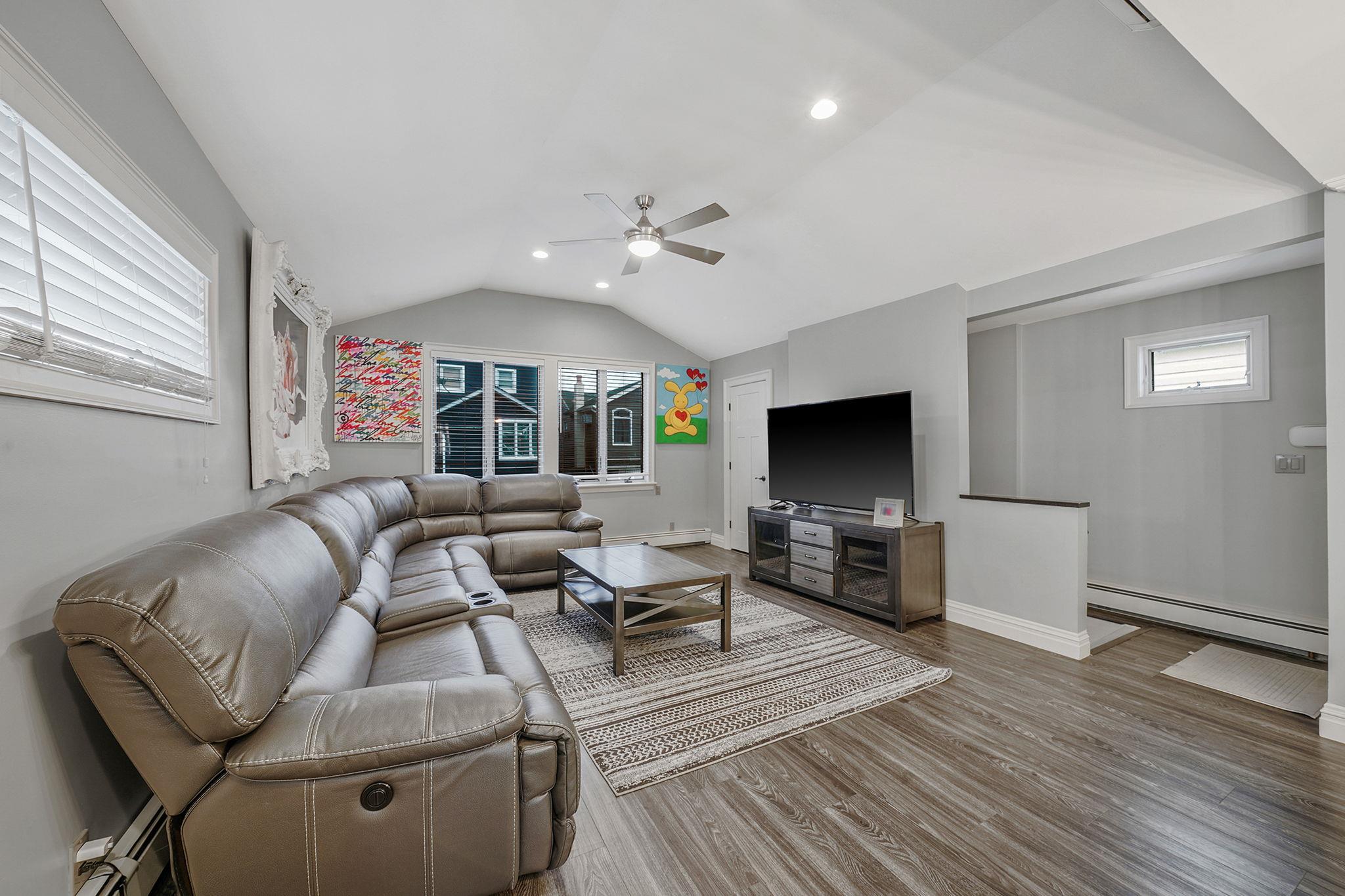 28 West 13th Road Queens, NY 11693 - Photo 23 of 37 a living room with furniture flat screen tv and a fireplace