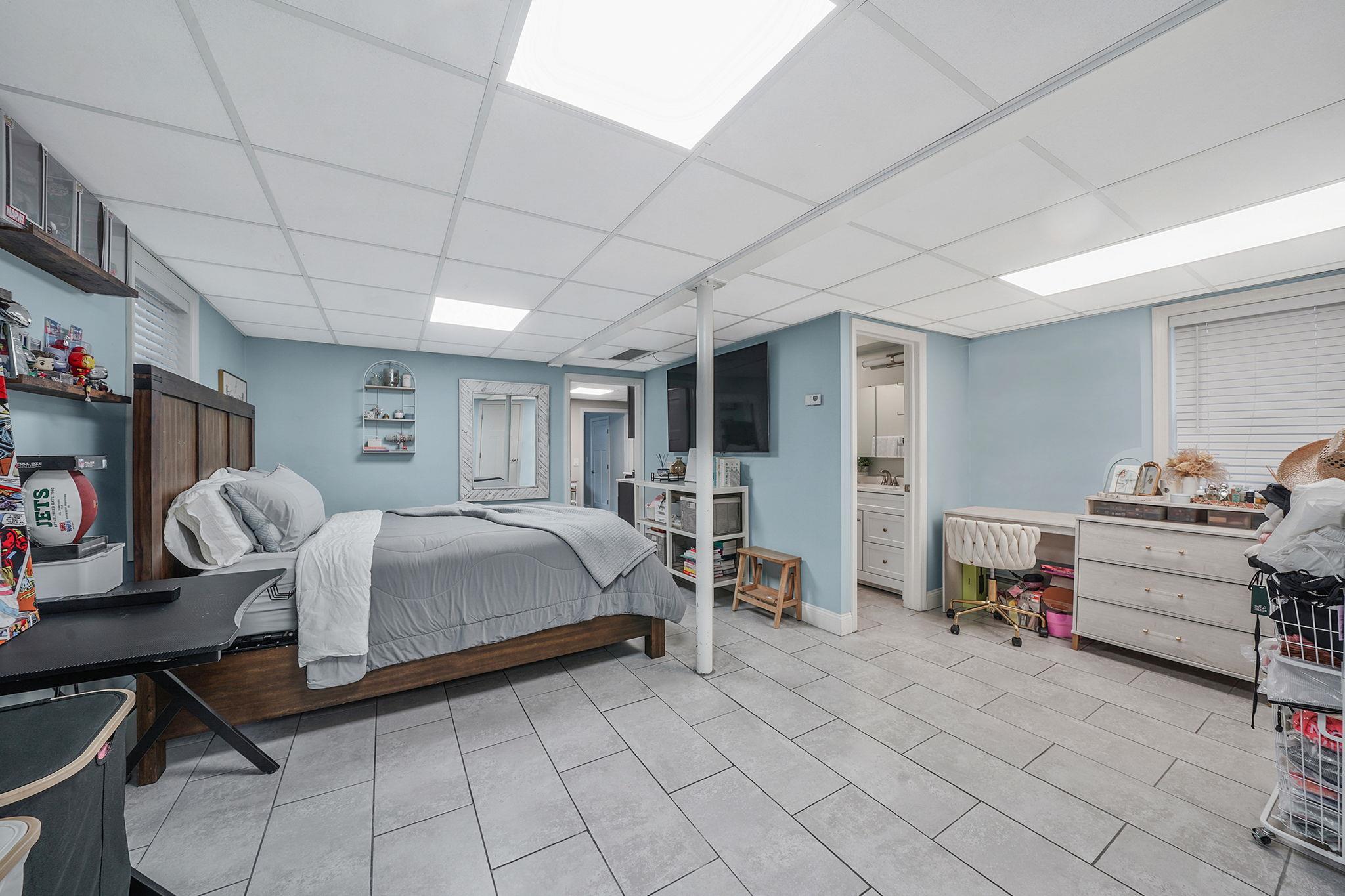 28 West 13th Road Queens, NY 11693 - Photo 10 of 37 a spacious bedroom with a bed and a desk