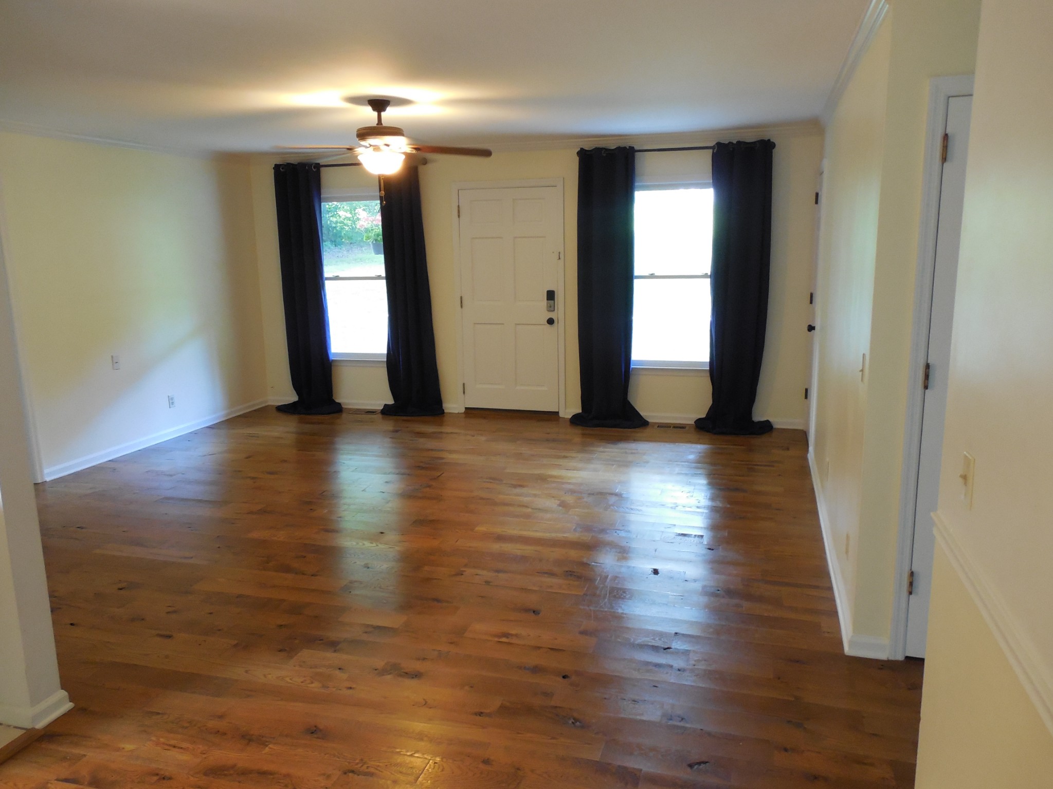 7397 Forest Glenn Road Fairview, TN 37062 - Photo 8 of 16 an empty room with wooden floor and windows