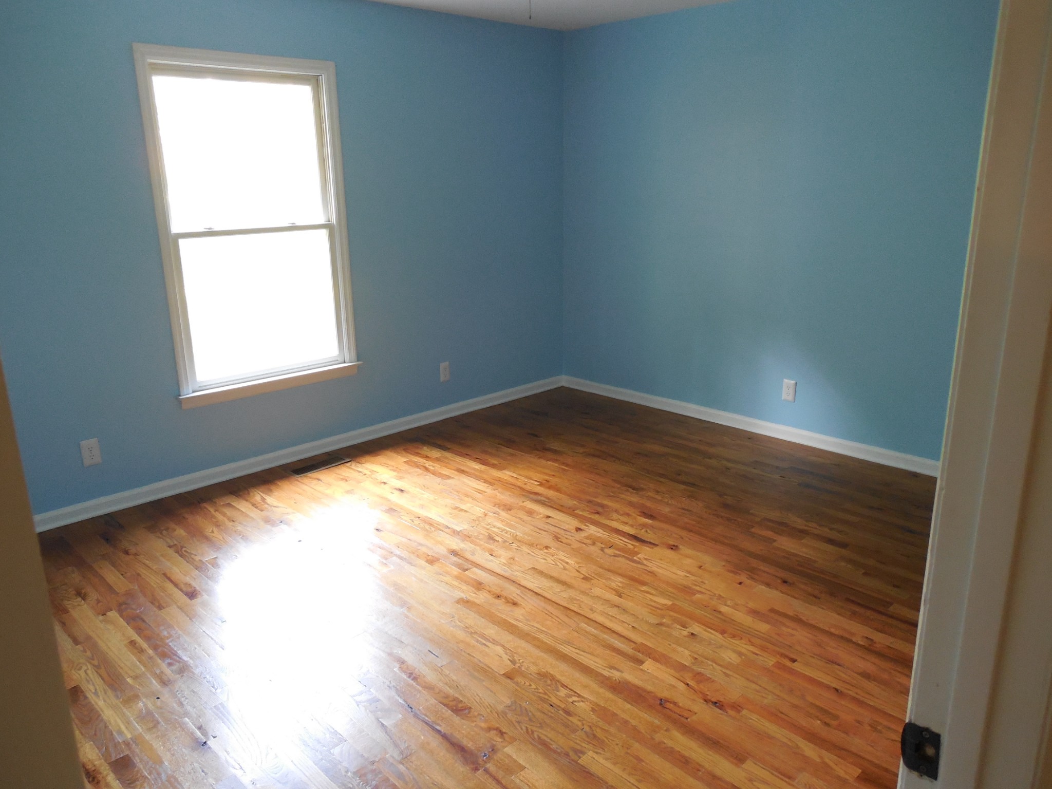 7397 Forest Glenn Road Fairview, TN 37062 - Photo 9 of 16 an empty room with wooden floor and windows