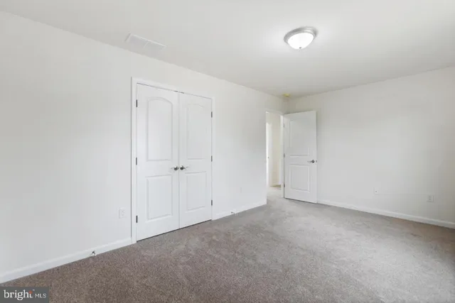 a view of an empty room and entryway