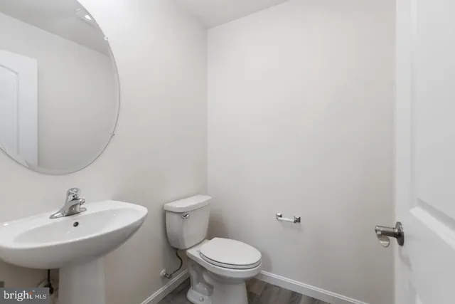 a bathroom with a sink a toilet and mirror