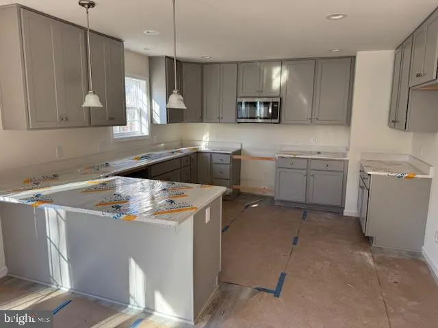 a kitchen that has a sink and cabinets in it