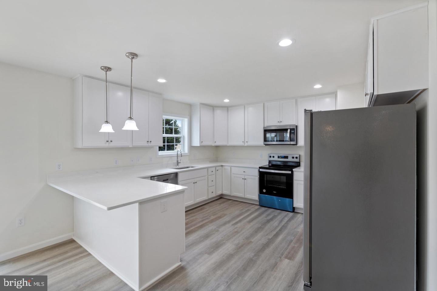 144 Pratts Branch Road Felton, DE 19943 - Photo 8 of 24 a kitchen with stainless steel appliances a refrigerator sink and stove