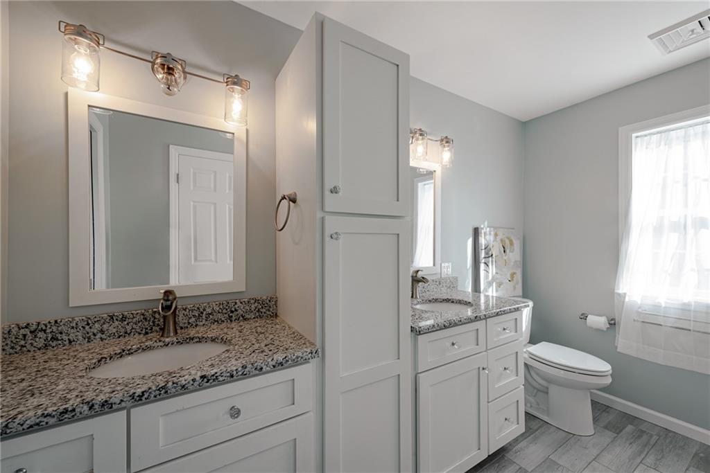 700 Springfield Road Penn Run, PA 15765 - Photo 17 of 25 a bathroom with a granite countertop sink toilet and mirror