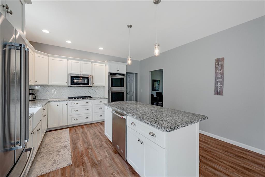 700 Springfield Road Penn Run, PA 15765 - Photo 8 of 25 a kitchen with granite countertop white cabinets and stainless steel appliances