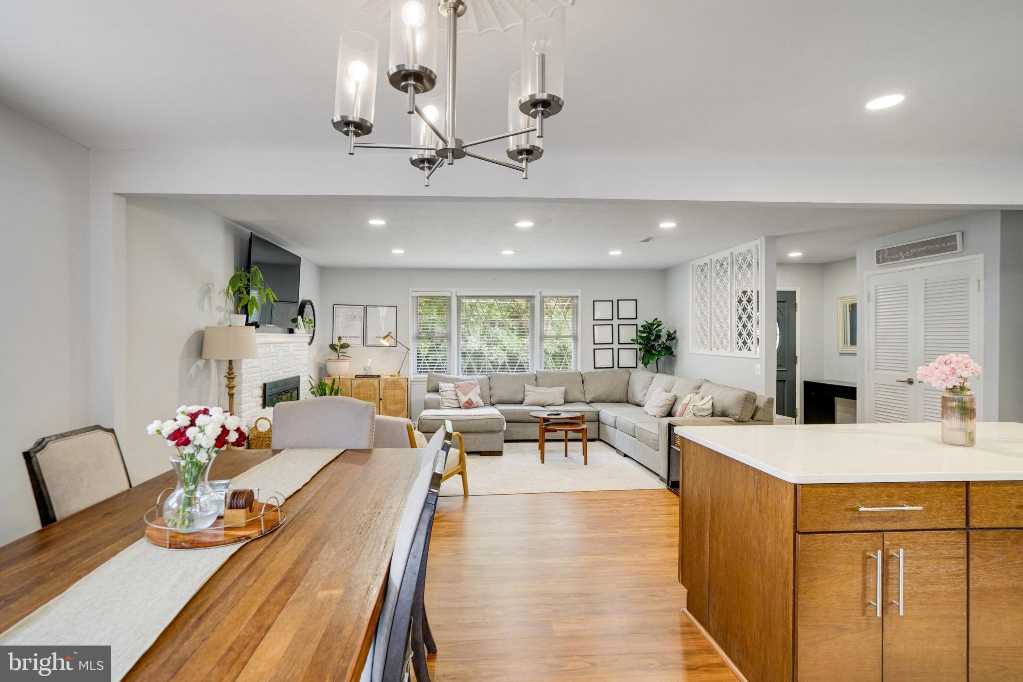 5904 Atteentee Road Springfield, VA 22150 - Photo 12 of 51 a view of a dining room with furniture a chandelier and wooden floor