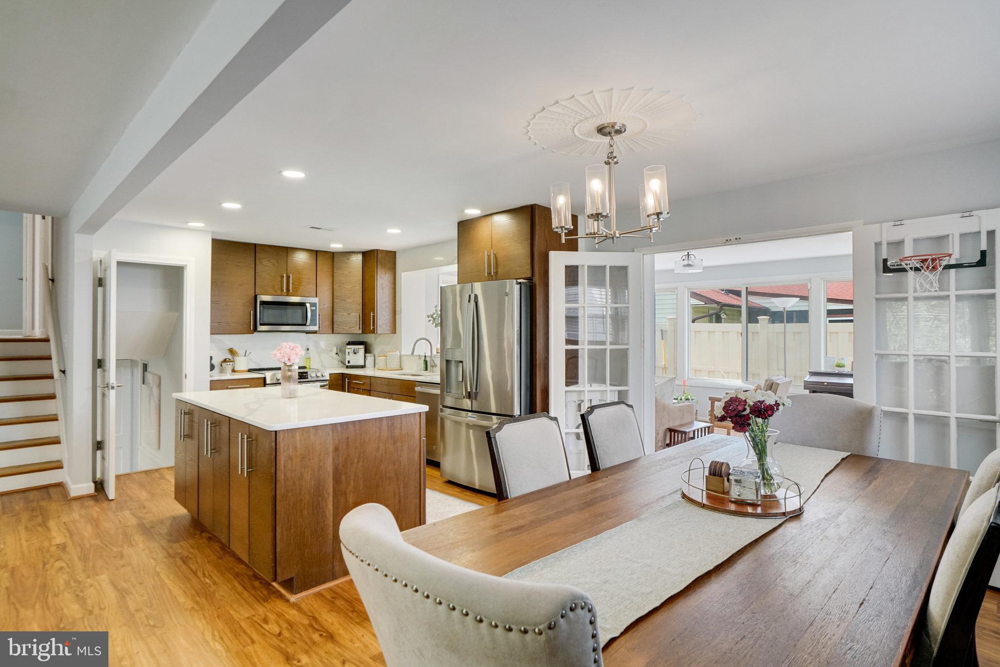 5904 Atteentee Road Springfield, VA 22150 - Photo 13 of 51 a dining room with stainless steel appliances furniture a chandelier and kitchen view