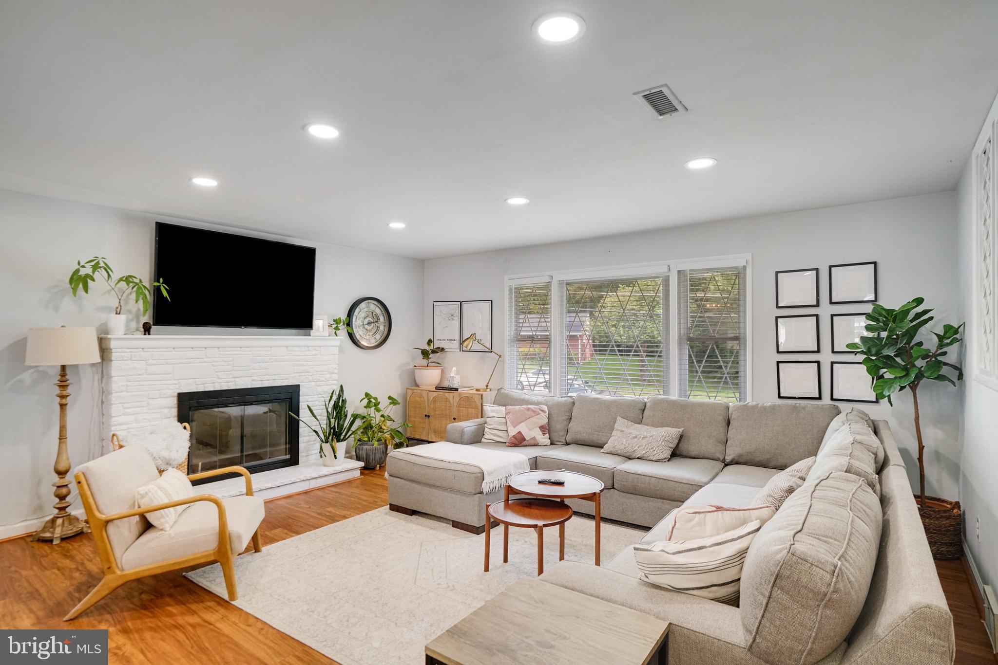 5904 Atteentee Road Springfield, VA 22150 - Photo 14 of 51 a living room with furniture a fireplace and a flat screen tv