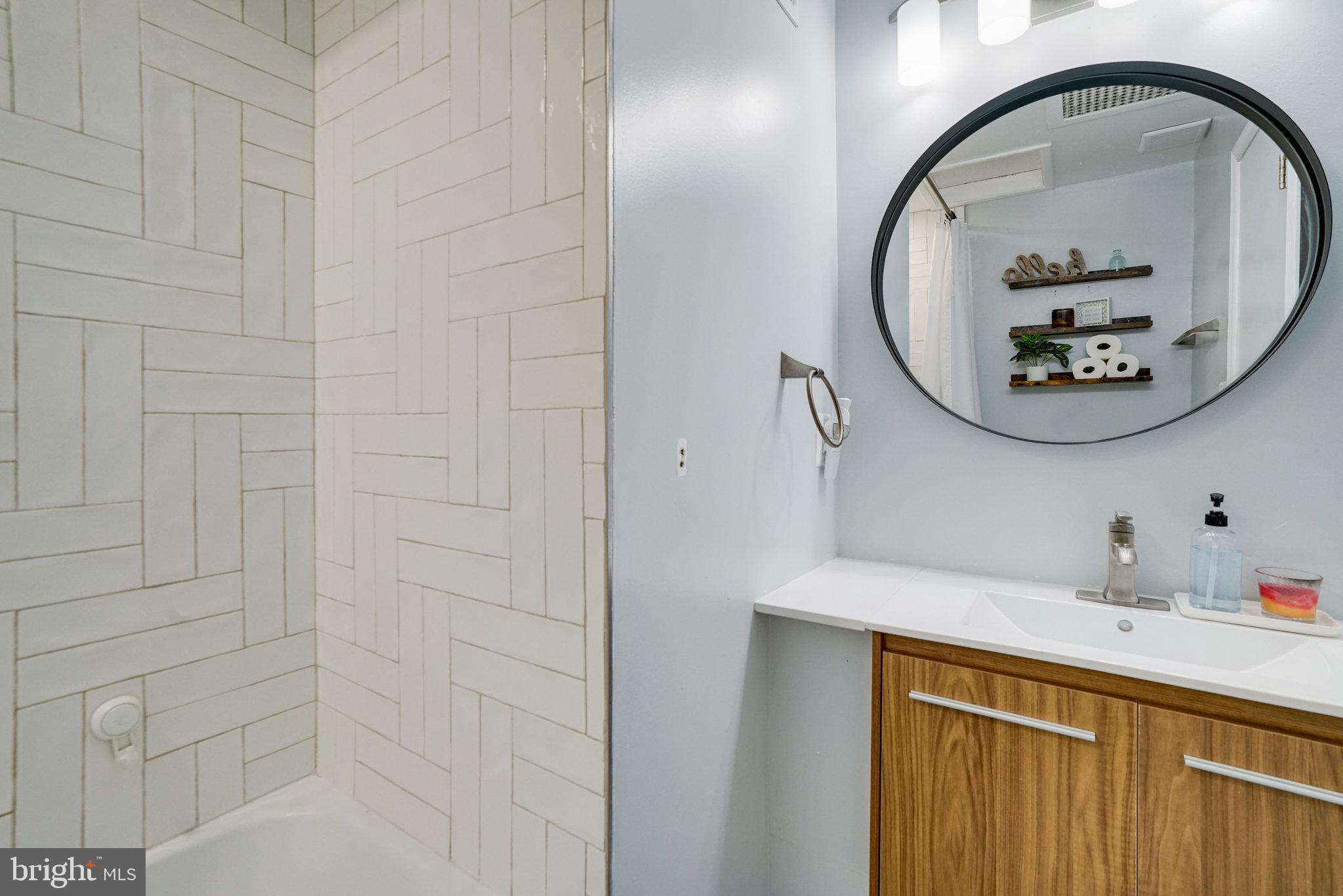 5904 Atteentee Road Springfield, VA 22150 - Photo 26 of 51 a bathroom with a sink and a mirror