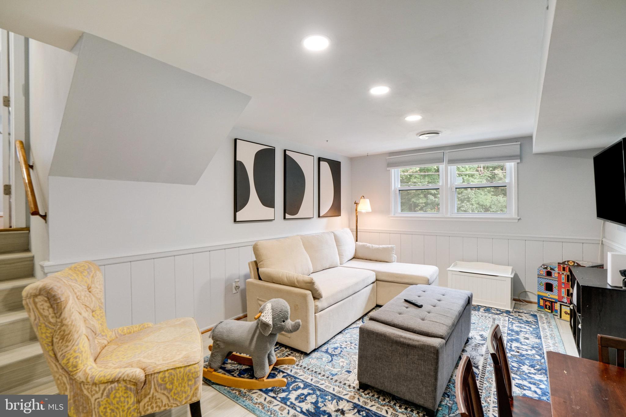 5904 Atteentee Road Springfield, VA 22150 - Photo 36 of 51 a living room with furniture a flat screen tv and a window