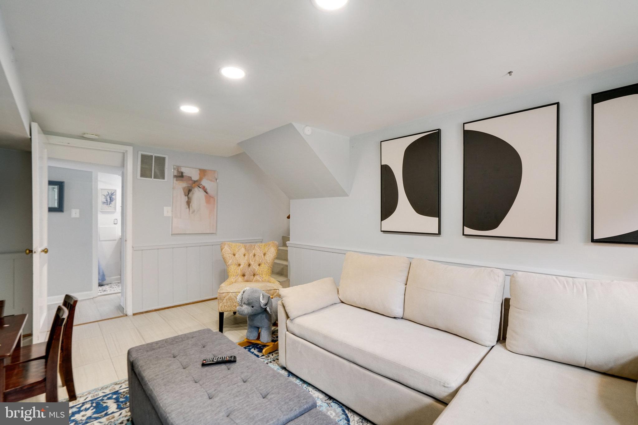 5904 Atteentee Road Springfield, VA 22150 - Photo 37 of 51 a living room with furniture and a painting on the wall