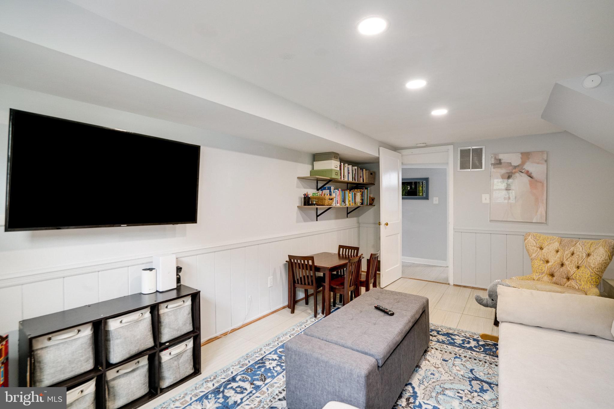 5904 Atteentee Road Springfield, VA 22150 - Photo 38 of 51 a living room with furniture and a flat screen tv