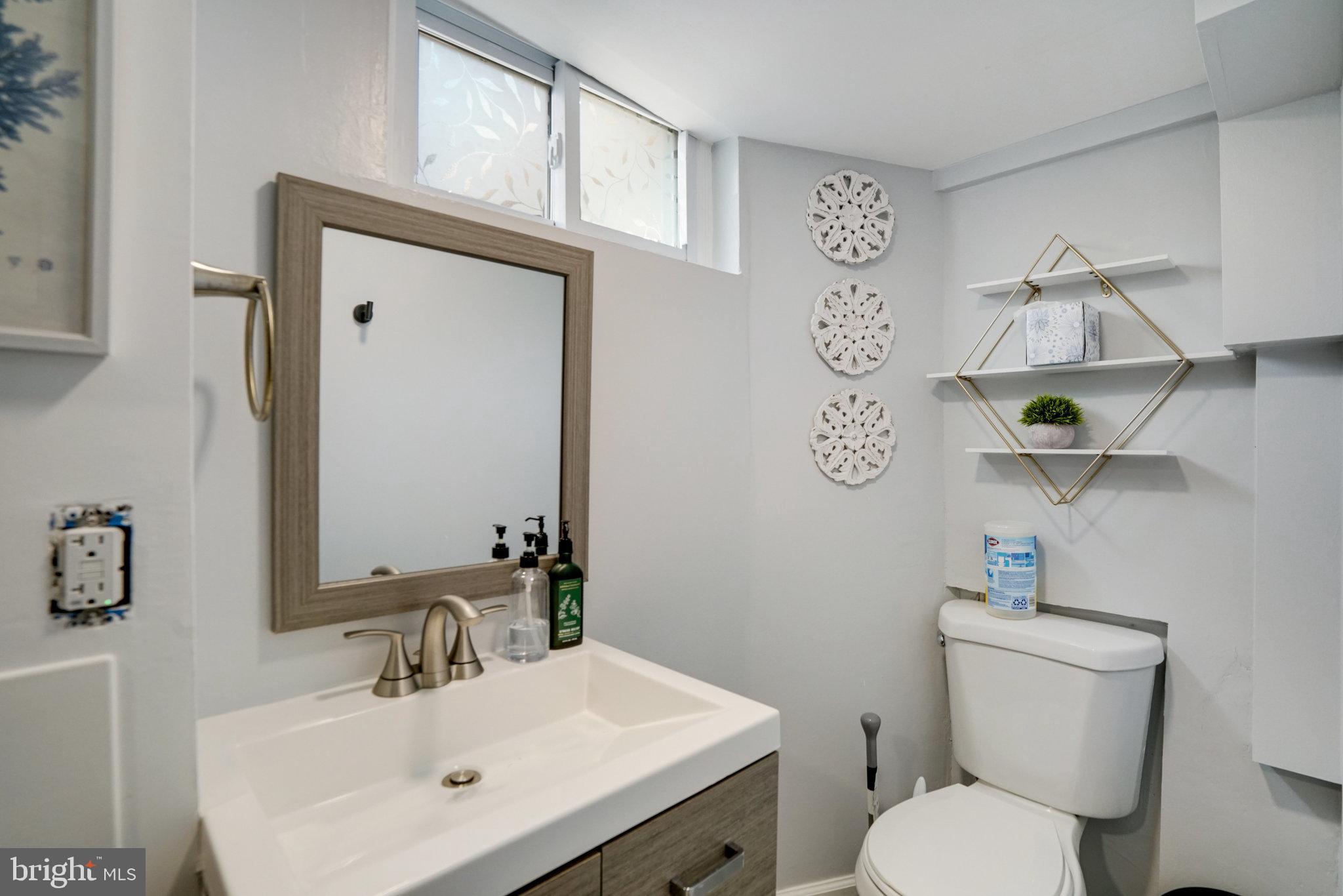 5904 Atteentee Road Springfield, VA 22150 - Photo 40 of 51 a bathroom with a toilet sink vanity and mirror