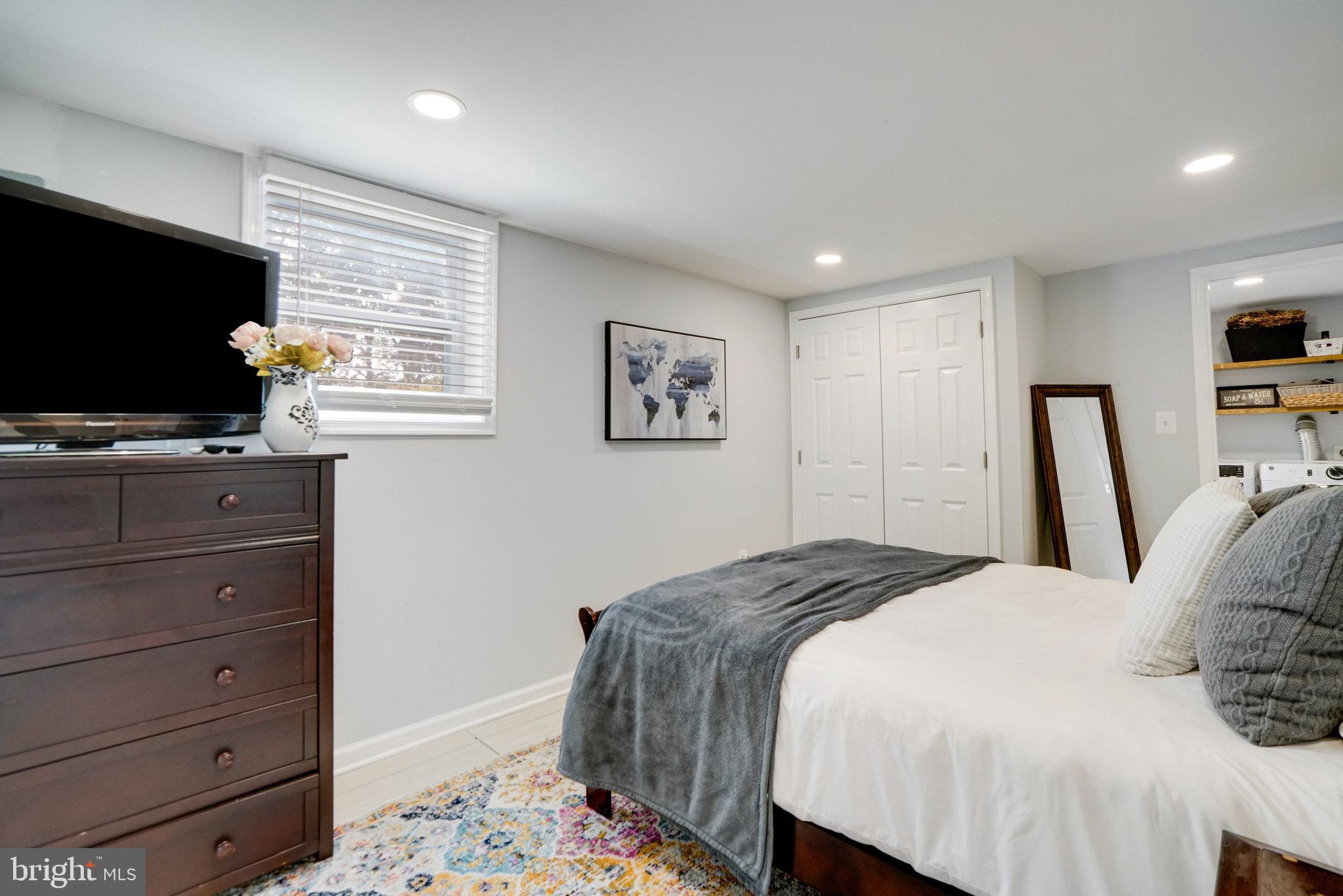 5904 Atteentee Road Springfield, VA 22150 - Photo 42 of 51 a bedroom with a bed and a flat screen tv