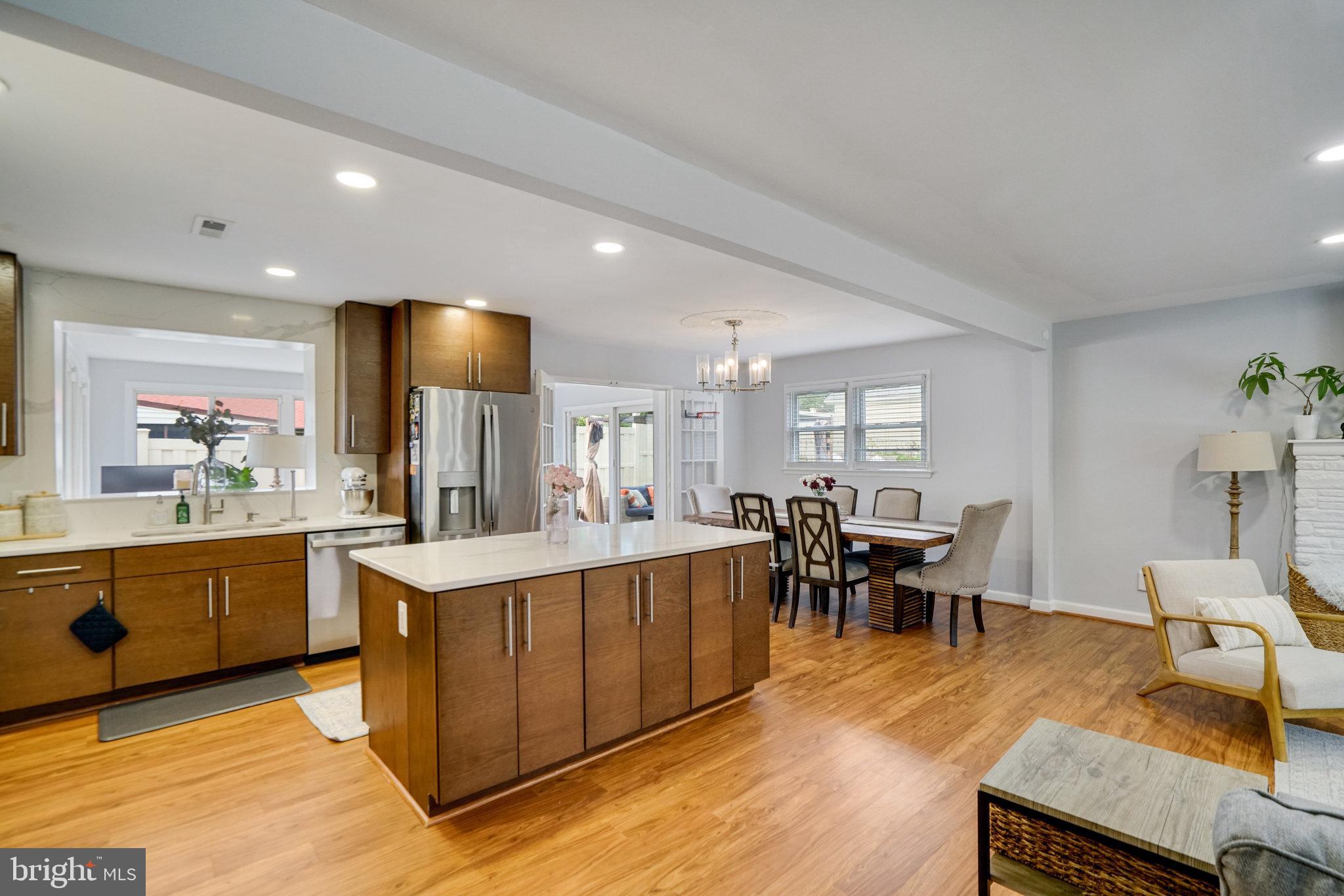 5904 Atteentee Road Springfield, VA 22150 - Photo 7 of 51 a large kitchen with kitchen island a sink table and chairs