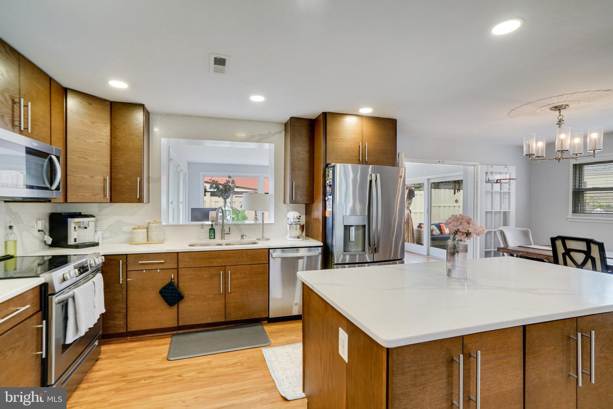 5904 Atteentee Road Springfield, VA 22150 - Photo 8 of 51 a kitchen with kitchen island a sink appliances and cabinets