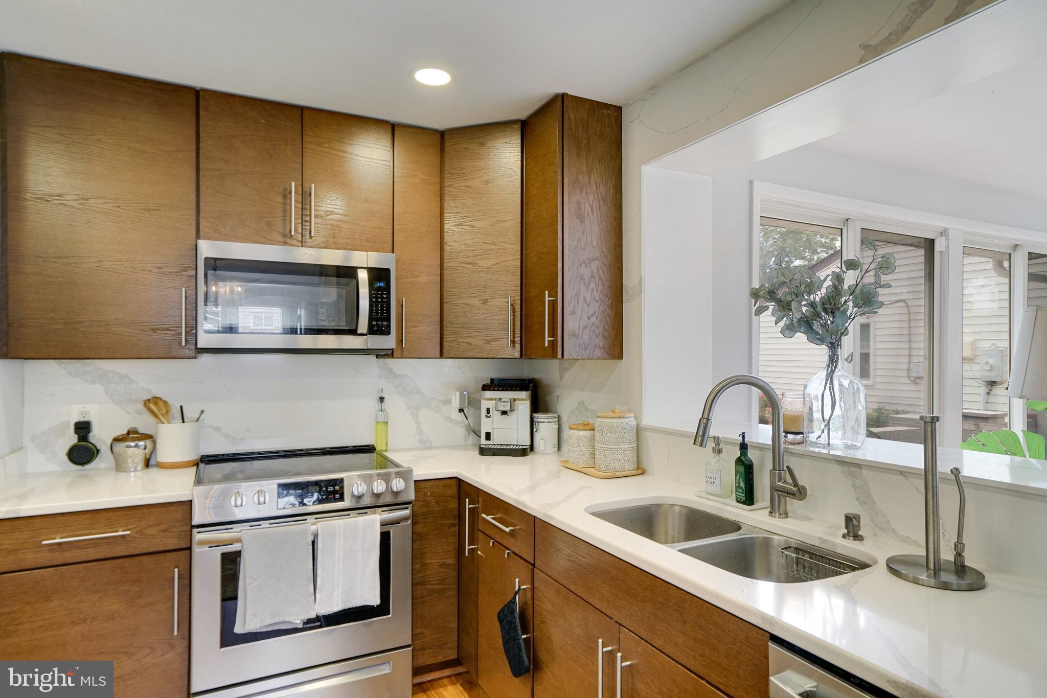 5904 Atteentee Road Springfield, VA 22150 - Photo 10 of 51 a kitchen with a sink a stove and cabinets