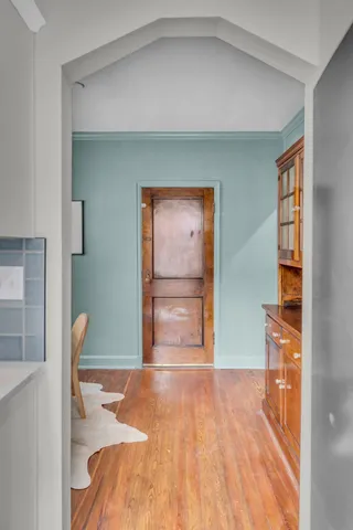 a kitchen with a refrigerator and white cabinets