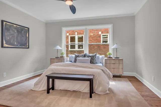 a bedroom with a bed and a painting on the wall