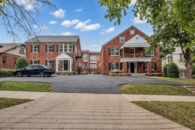 a front view of a residential houses with yard