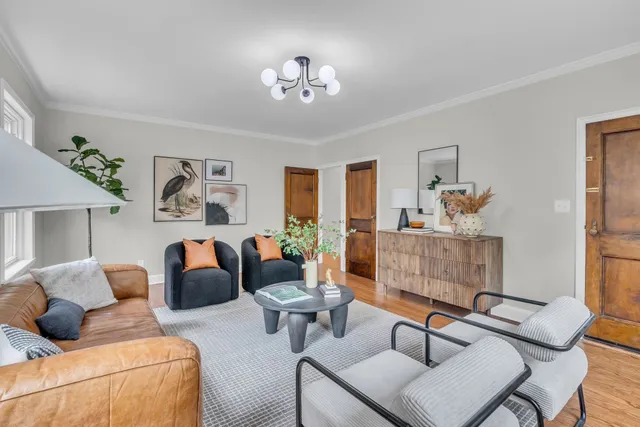 a living room with furniture potted plant and a window