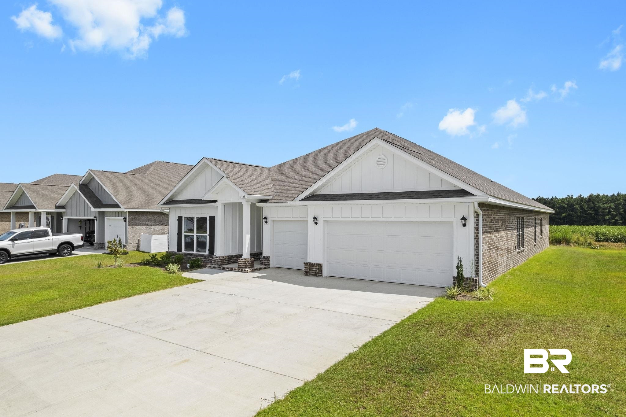11303 Genuine Risk Circle Daphne, AL 36526 - Photo 82 of 100 View of front facade featuring a garage and a front yard