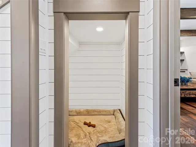 a view of entryway with wooden floor and livingroom view