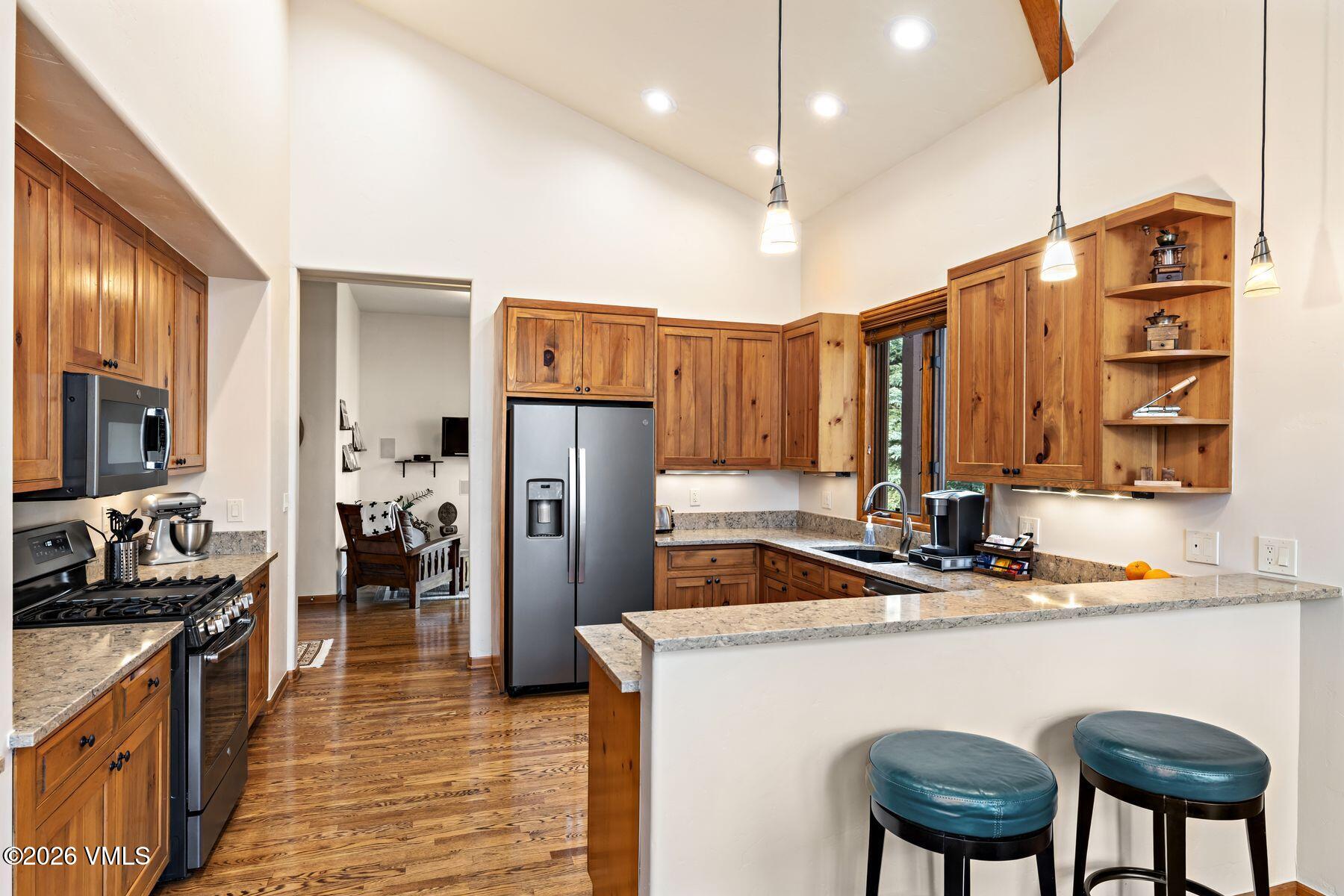 91 Creamery Trail Edwards, CO 81632 - Photo 10 of 44 a kitchen with stainless steel appliances granite countertop a sink refrigerator and cabinets