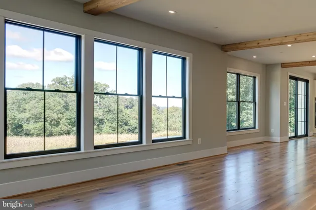 a view of an entryway with wooden floor and windows